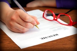 Filling resume on wooden table, close-up