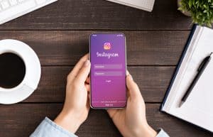 Woman Holding a phone with Instagram
